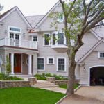 A large house with a tree in front of it.