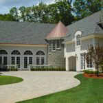 A large house with a curved driveway in front of it.