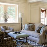 A living room with two chairs, a couch and a table.