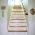 A staircase with white steps and wooden handrails.