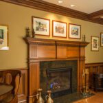 A fireplace with wood mantle and mantel surround.