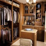 A closet with many wooden cabinets and shelves