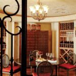 A dining room with wine racks and tables