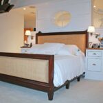 A bed room with a white bed and two nightstands