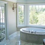 A large bathroom with a tub and a window.