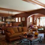 A living room with couches, tables and chairs.