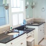 A bathroom with two sinks and a mirror