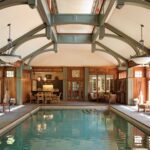 A large indoor swimming pool with wooden beams.