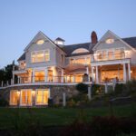 A large white house sitting on top of a hill.