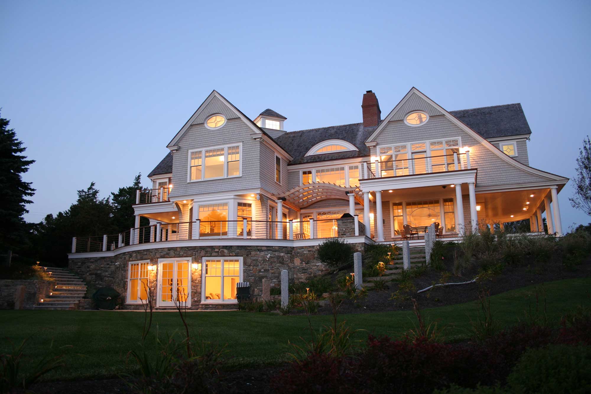 A large white house sitting on top of a hill.