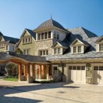 A large house with many windows and a garage.