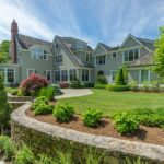 A large house with a garden in the front yard.