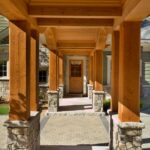 A long walkway with pillars and stone columns.