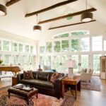 A living room with two large windows and a couch