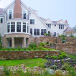 A large house with a garden in the foreground.