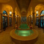 A large indoor pool with many pillars and lights.