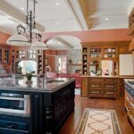 A large kitchen with wooden floors and cabinets.