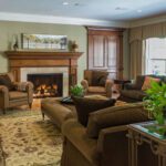 A living room with couches, chairs and a fireplace.