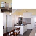 A kitchen with white cabinets and black counter tops.