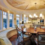 A dining room with a round table and chairs