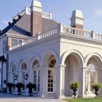 A large white building with columns and arches.