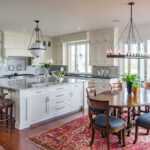 A kitchen with a dining table and chairs