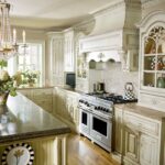 A kitchen with white cabinets and wood floors.