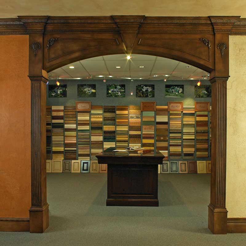 A room with many different colored walls and a wooden arch.